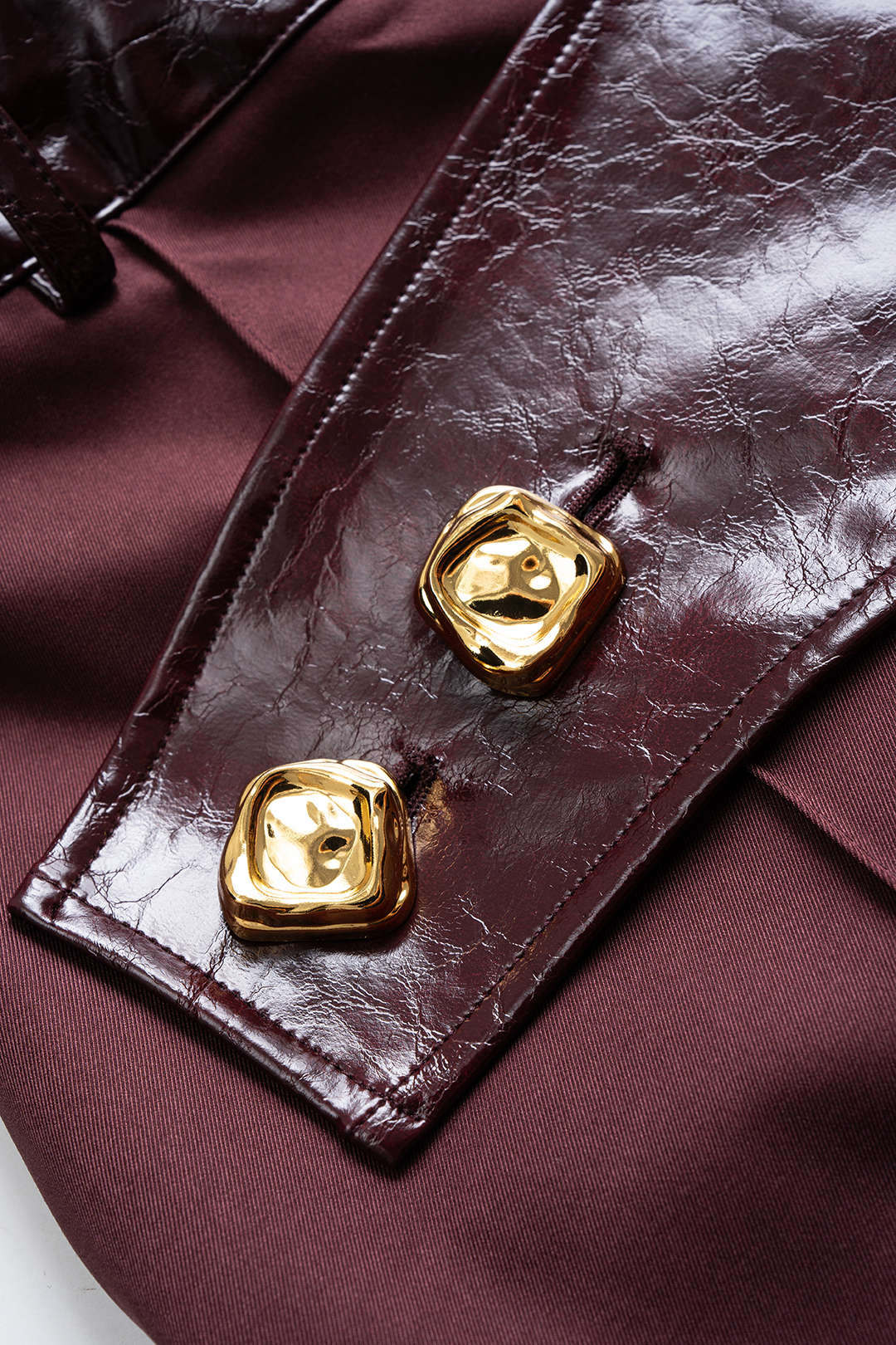 Hose aus Kunstleder-Patchwork mit asymmetrischem Metallic-Knopf und weitem Bein